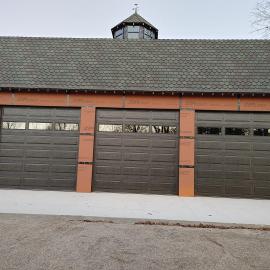 Three car garage doors with windows