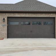 Two car garage door with windows and decorative hardware